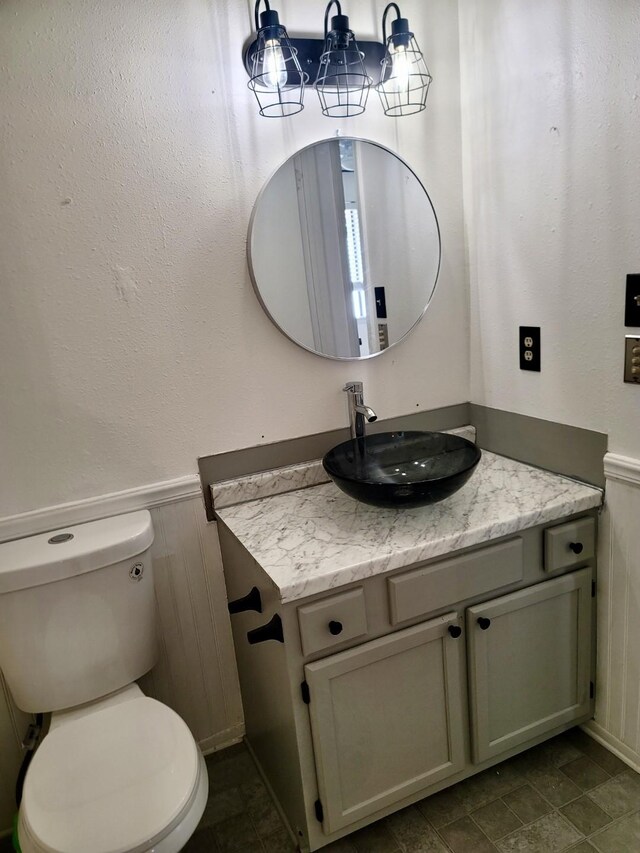 bathroom with walk in shower, vanity, toilet, and a textured ceiling