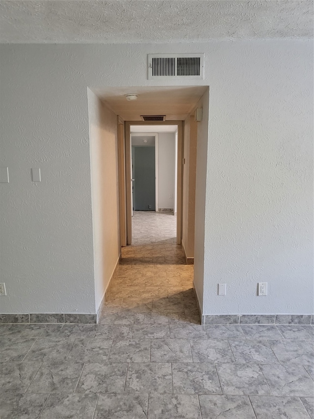 empty room with a textured ceiling