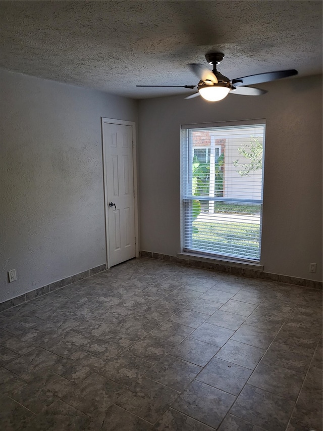 unfurnished room featuring a textured ceiling and ceiling fan