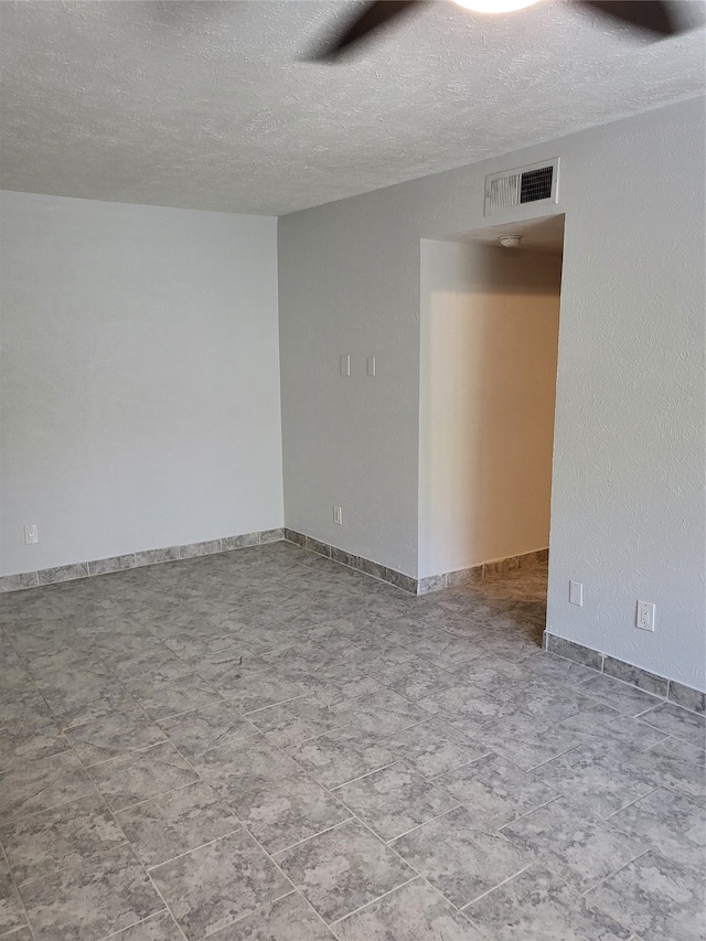 empty room featuring a textured ceiling and ceiling fan