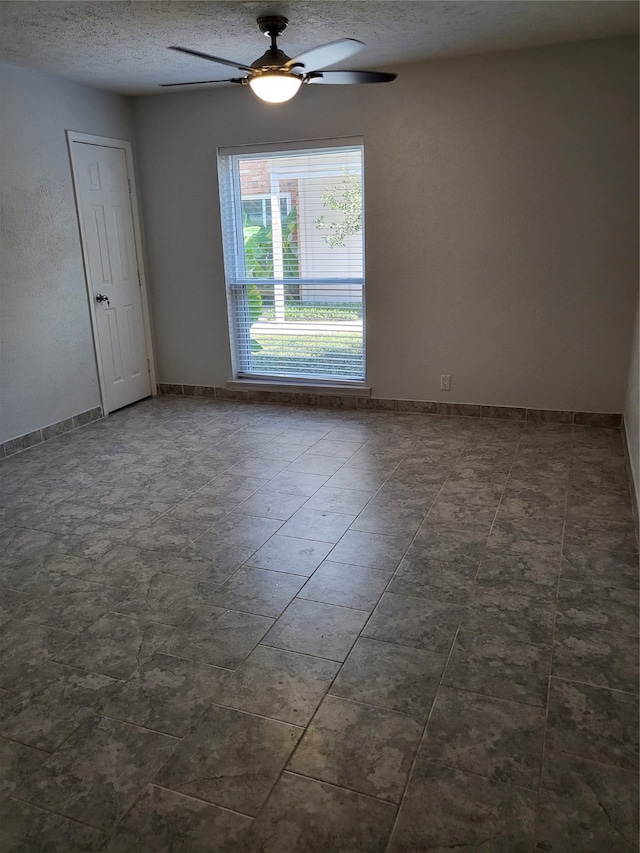 unfurnished room featuring a textured ceiling and ceiling fan