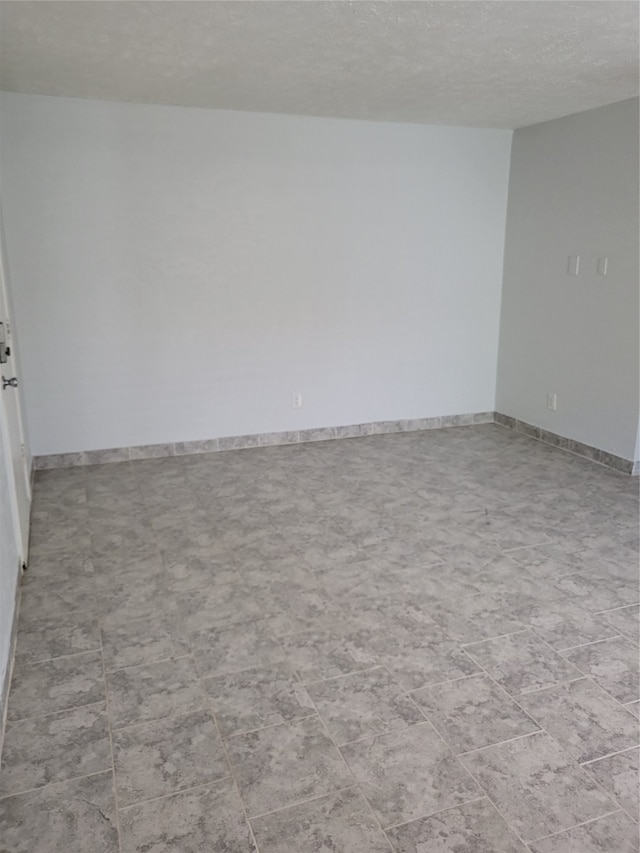 spare room featuring a textured ceiling