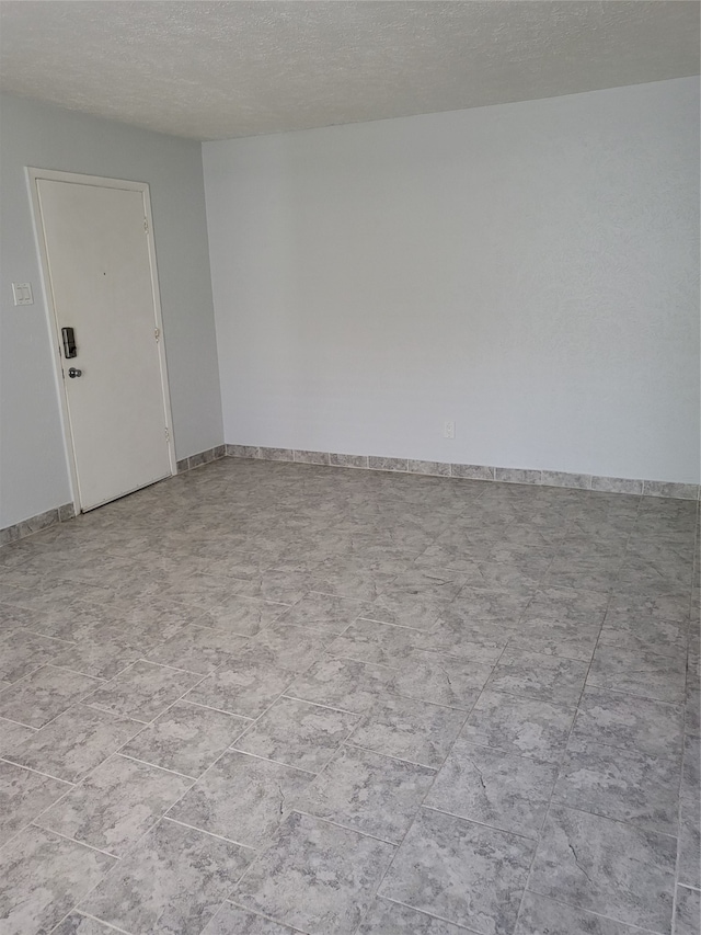 empty room featuring a textured ceiling