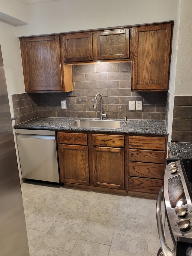 kitchen with appliances with stainless steel finishes, backsplash, and sink