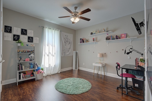 home office with ceiling fan and dark hardwood / wood-style floors