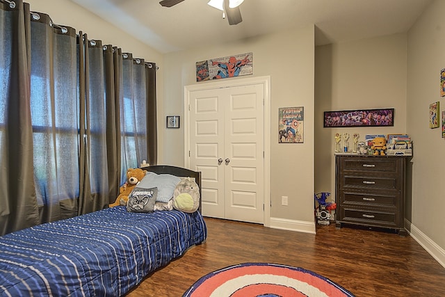 bedroom with ceiling fan, a closet, and dark hardwood / wood-style floors