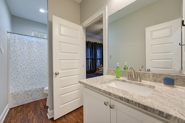 bathroom featuring hardwood / wood-style floors, vanity, toilet, and a shower with curtain