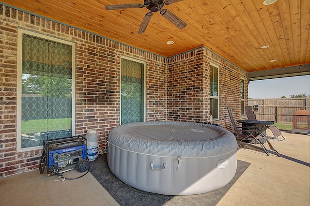 view of patio with a hot tub and ceiling fan