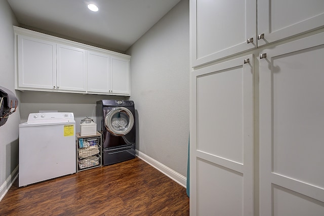 laundry room with cabinets, dark hardwood / wood-style floors, and washing machine and dryer