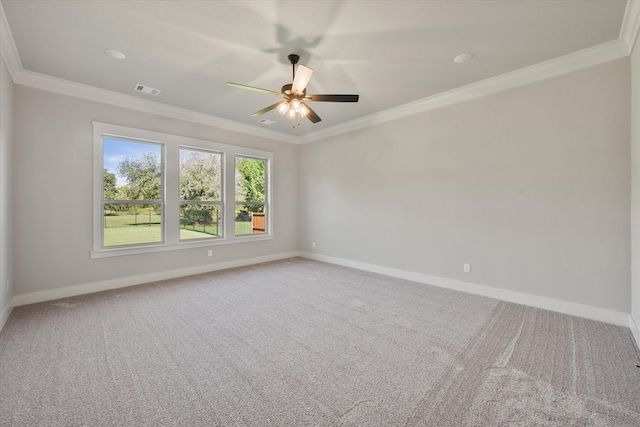 carpeted spare room featuring crown molding and ceiling fan