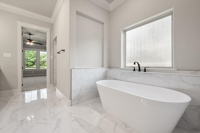 bathroom featuring ceiling fan, a bathing tub, ornamental molding, and tile walls