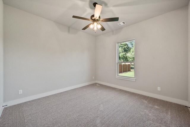 spare room featuring ceiling fan and carpet