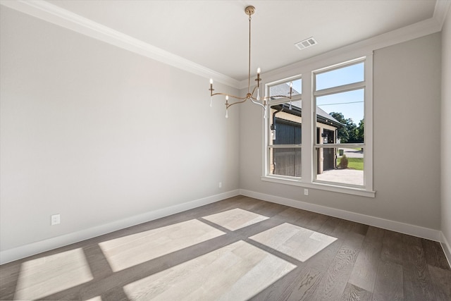 unfurnished dining area with ornamental molding, a chandelier, plenty of natural light, and hardwood / wood-style floors