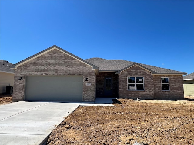 102 Levi Dr, Cleburne, TX 76031 - single story home with an attached garage, brick siding, driveway, and cooling unit