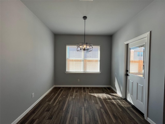 102 Levi Dr, Cleburne, TX 76031 - unfurnished dining area with dark wood-type flooring, a chandelier, and baseboards