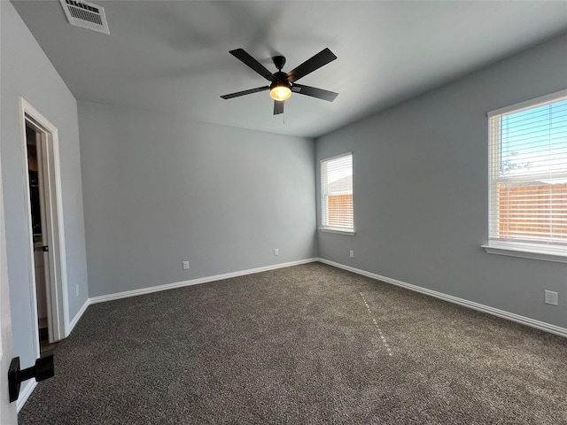 102 Levi Dr, Cleburne, TX 76031 - spare room featuring ceiling fan, dark colored carpet, and baseboards