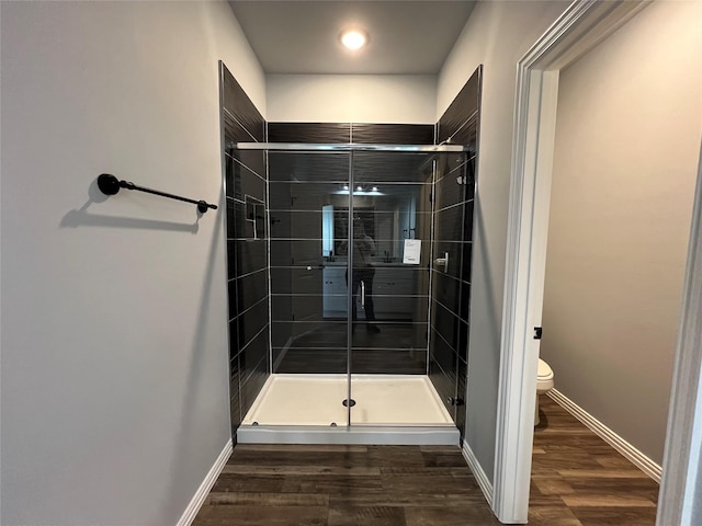 102 Levi Dr, Cleburne, TX 76031 - bathroom with toilet, a shower stall, wood finished floors, and baseboards