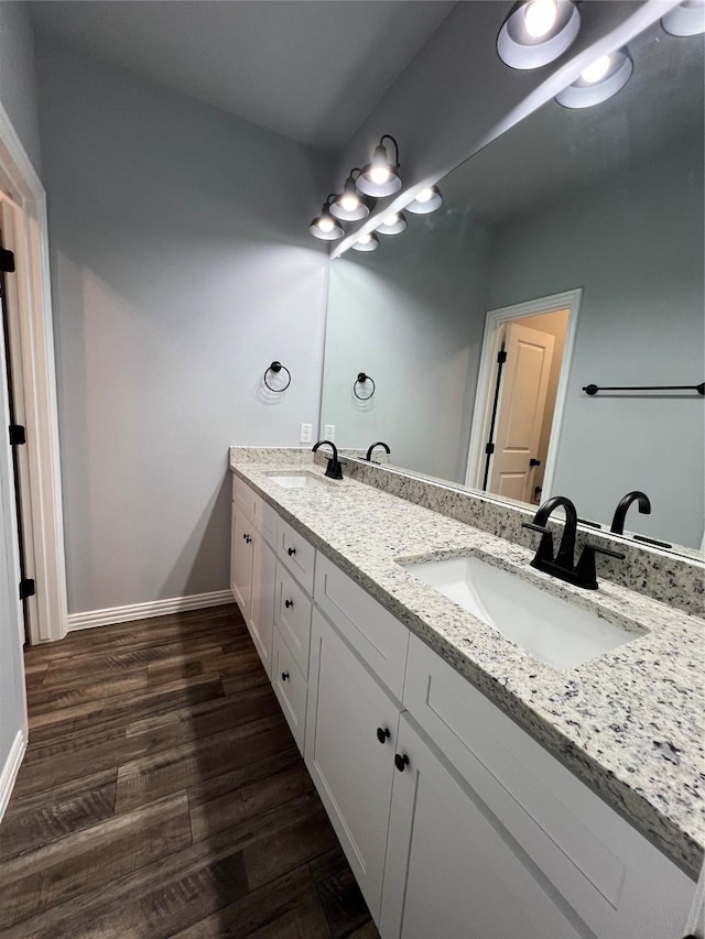 102 Levi Dr, Cleburne, TX 76031 - bathroom featuring double vanity, baseboards, and wood finished floors