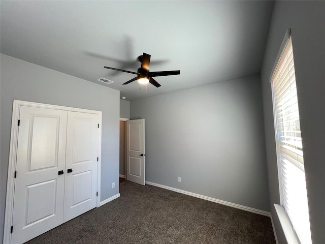 102 Levi Dr, Cleburne, TX 76031 - unfurnished bedroom with dark colored carpet, baseboards, a closet, and ceiling fan