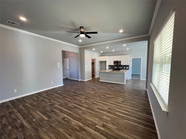 102 Levi Dr, Cleburne, TX 76031 - unfurnished living room with crown molding, dark wood finished floors, a ceiling fan, baseboards, and recessed lighting