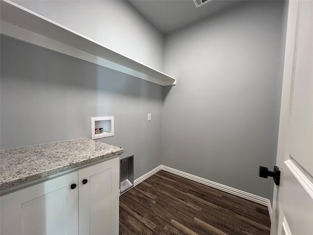 102 Levi Dr, Cleburne, TX 76031 - laundry area with hookup for a washing machine, dark wood-style flooring, cabinet space, and baseboards