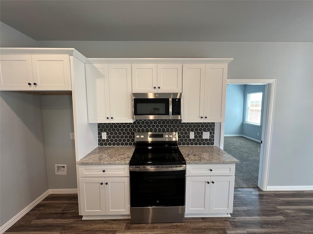 102 Levi Dr, Cleburne, TX 76031 - kitchen featuring appliances with stainless steel finishes, baseboards, white cabinetry, and backsplash