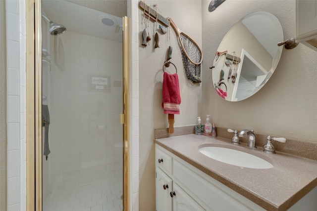 bathroom featuring vanity and a shower with shower door