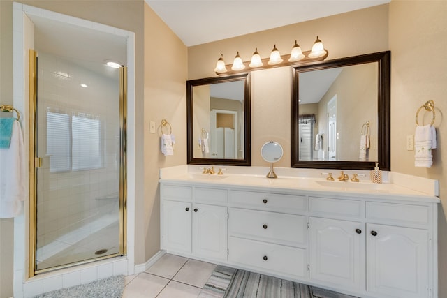 bathroom featuring tile patterned flooring, vanity, and an enclosed shower