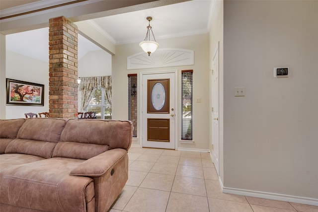 entryway with crown molding and light tile patterned floors