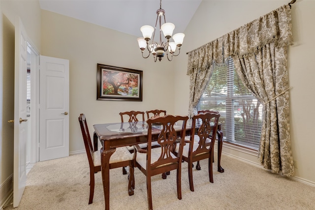 dining area featuring vaulted ceiling, light colored carpet, an inviting chandelier, and plenty of natural light