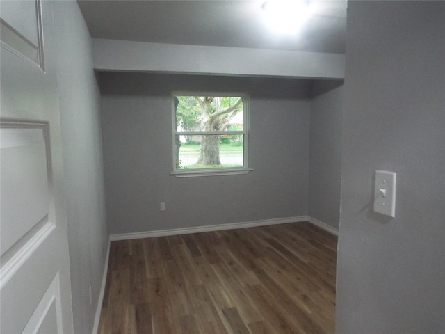 spare room featuring dark wood-type flooring