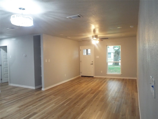 entryway with wood-type flooring and ceiling fan