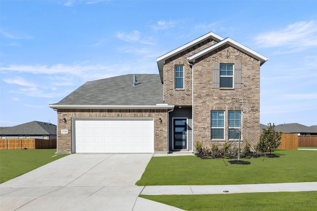 traditional-style home featuring brick siding, an attached garage, a front lawn, and fence