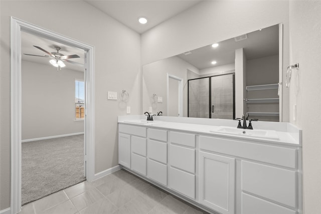 bathroom with tile patterned flooring, vanity, an enclosed shower, and ceiling fan