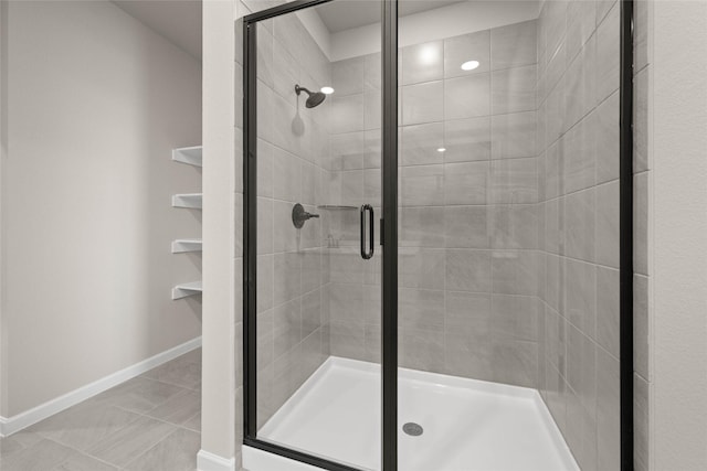 bathroom with tile patterned floors and walk in shower