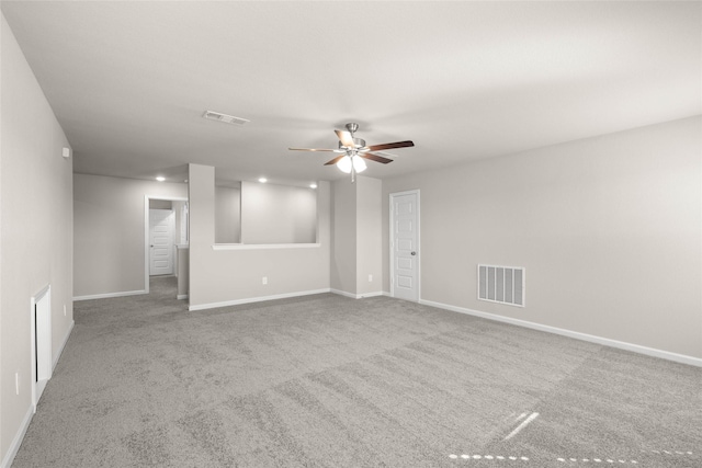 unfurnished room featuring ceiling fan and carpet