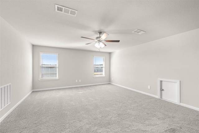 carpeted spare room with ceiling fan