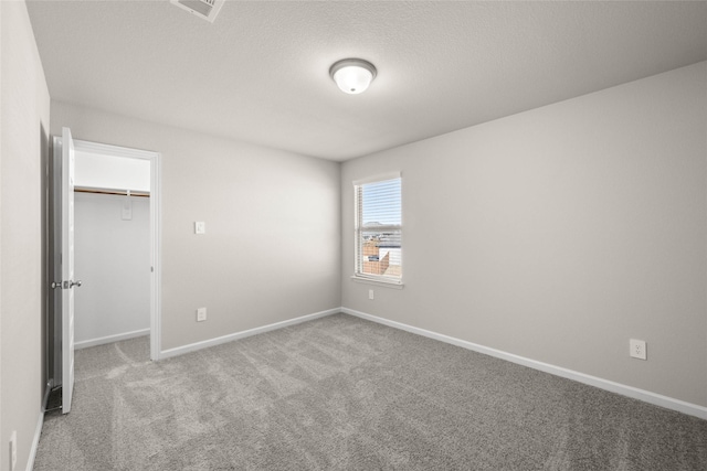 unfurnished bedroom featuring carpet and a closet