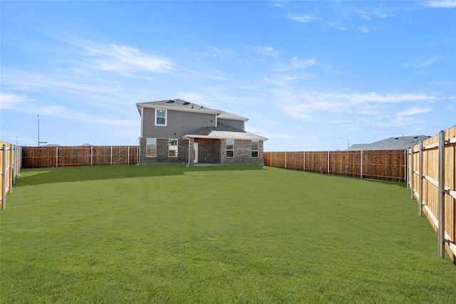 rear view of house with a lawn