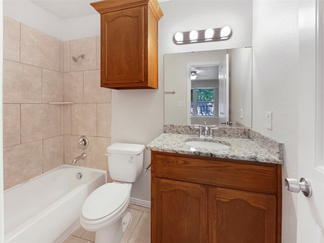 full bathroom with vanity, tiled shower / bath combo, toilet, and tile patterned floors