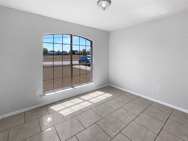 tiled spare room with plenty of natural light