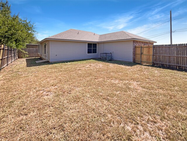 rear view of house with a yard