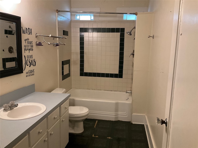 full bathroom featuring tiled shower / bath combo, vanity, and toilet