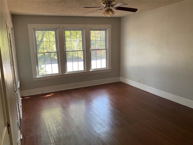 unfurnished room with a textured ceiling, dark hardwood / wood-style floors, and ceiling fan