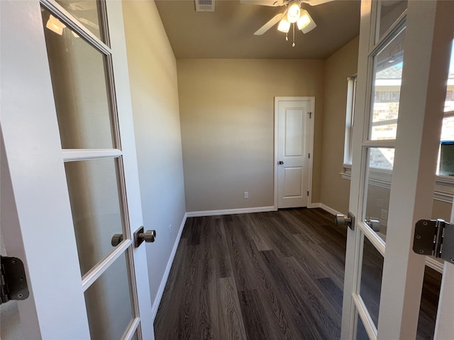 empty room featuring dark wood-type flooring and french doors