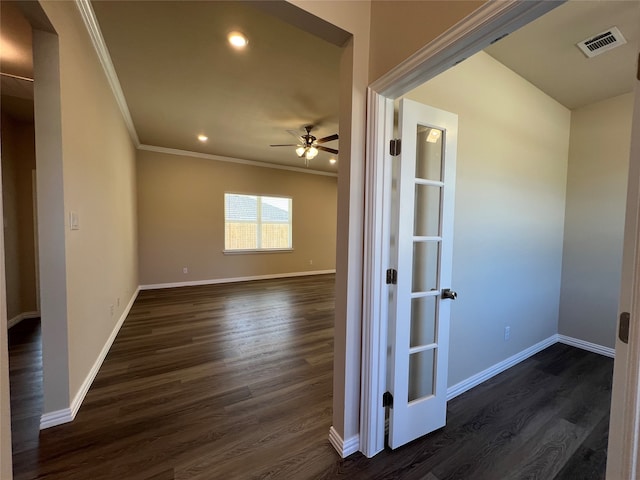 empty room featuring ceiling fan, dark hardwood / wood-style floors, and ornamental molding