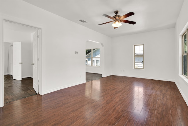 spare room featuring ceiling fan and dark wood-type flooring