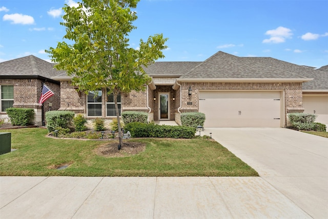 view of front of home featuring a front yard and a garage