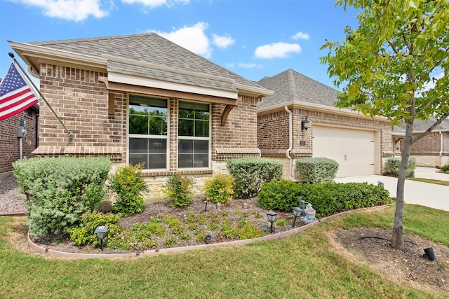 ranch-style house featuring a garage and a front lawn