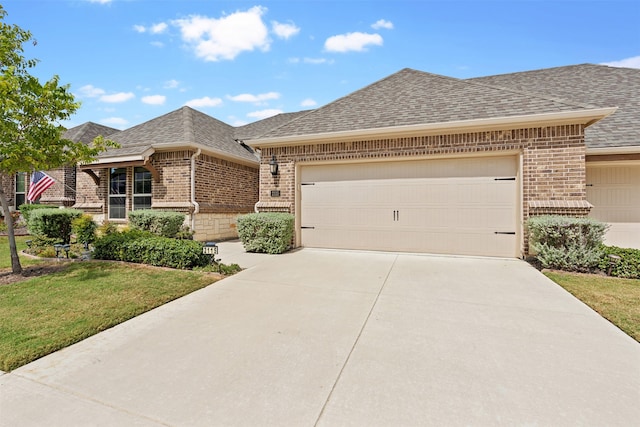 view of front of property featuring a front lawn and a garage